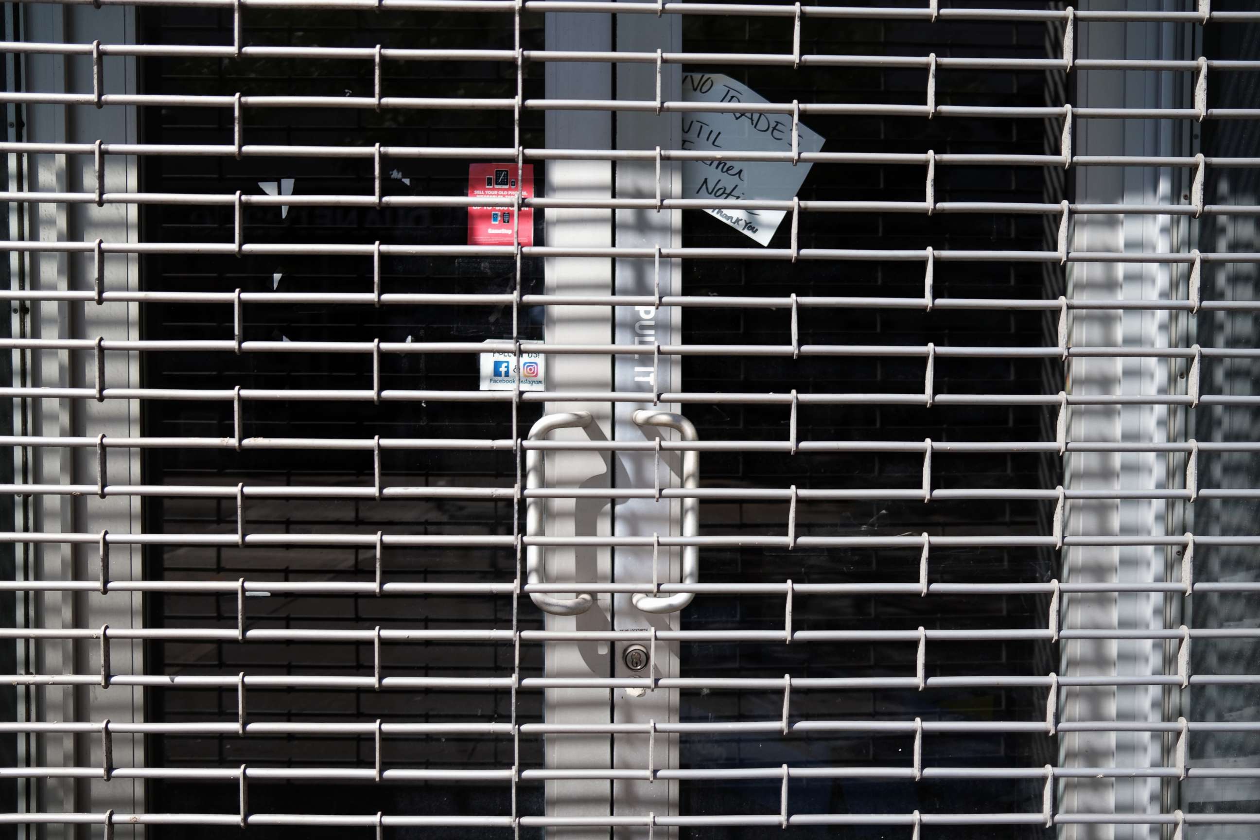 PHOTO: A metal grill covers the entrance of a closed business in the Brooklyn borough of New York, July 21, 2020.