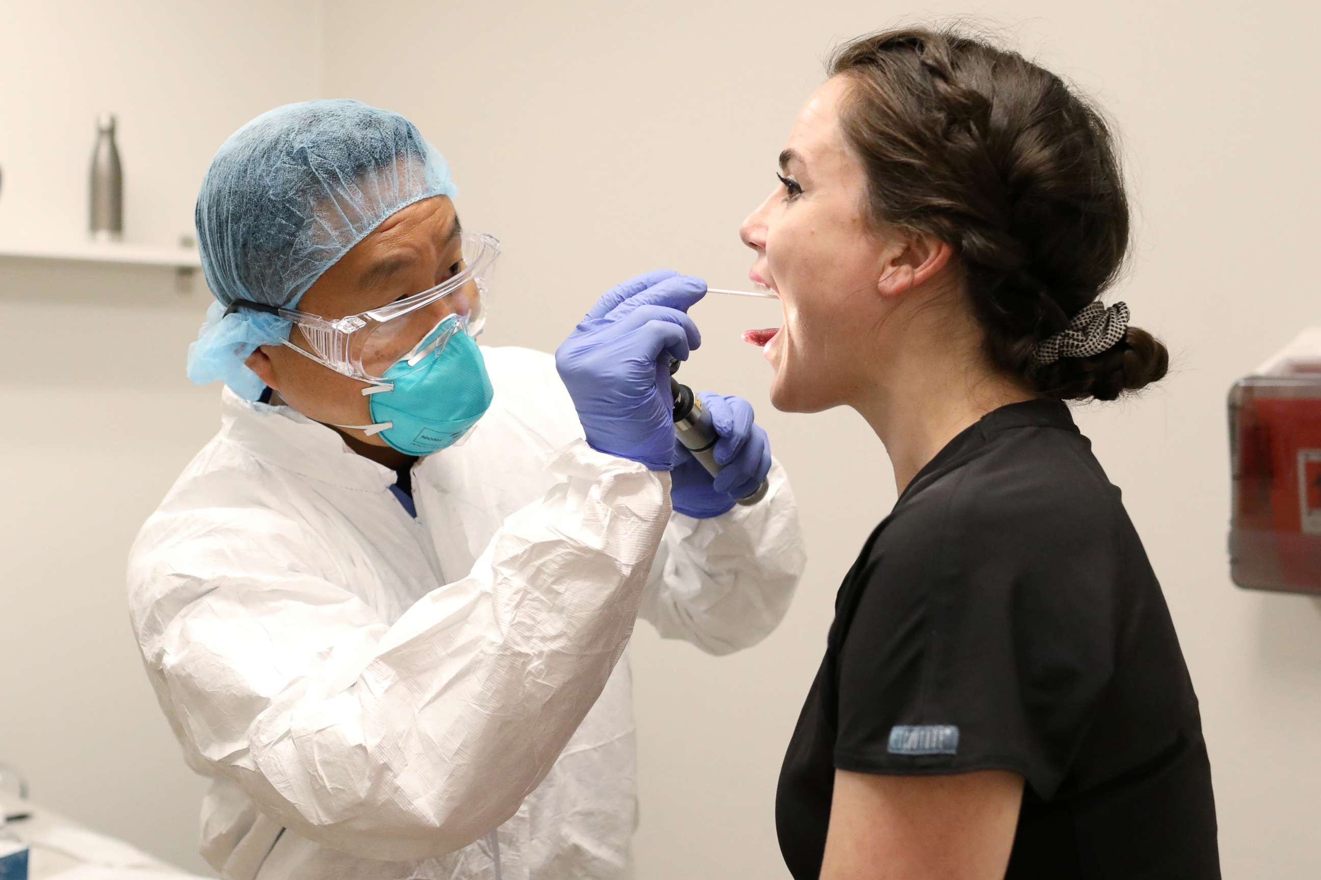 PHOTO: Physician John Jones, D.O. tests administrative assistant Morgan Bassin for the coronavirus disease (COVID-19) at One Medical in Scottsdale, Arizona, June 17, 2020.