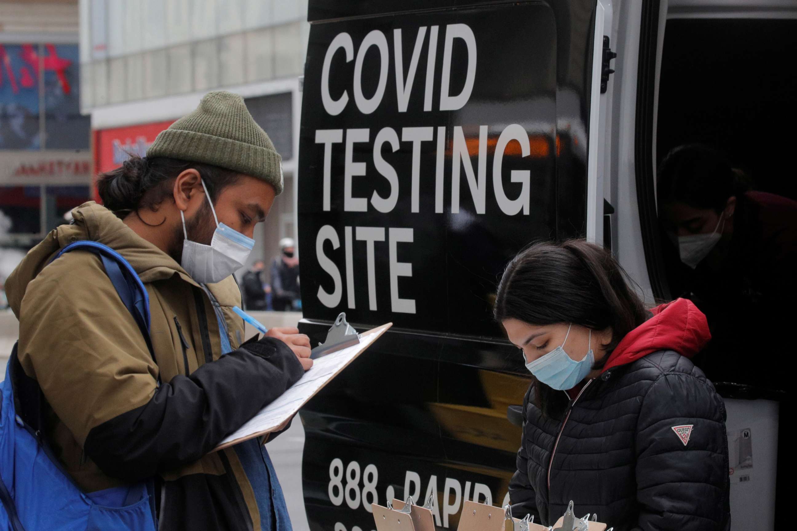 PHOTO: A man signs up to take a COVID-19 test at a mobile testing van in Herald Square in New York, March 16, 2021.