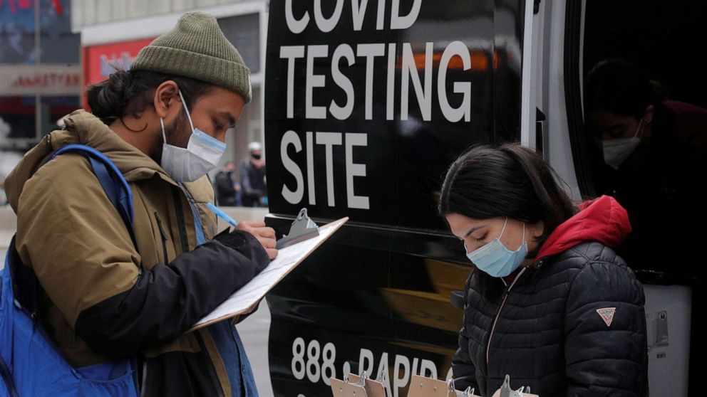 PHOTO: A man signs up to take a COVID-19 test at a mobile testing van in Herald Square in New York, March 16, 2021.