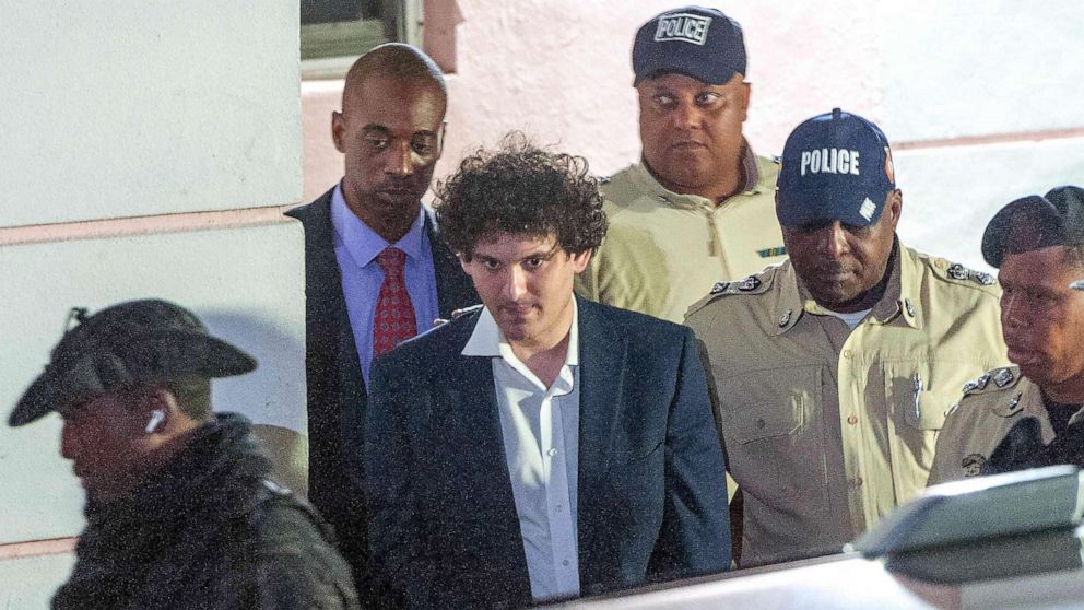 PHOTO: FTX founder Sam Bankman-Fried (C) is led away handcuffed by officers of the Royal Bahamas Police Force in Nassau, Bahamas, Dec. 13, 2022.