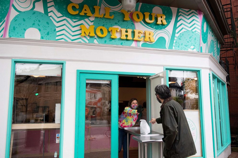 PHOTO: A person picks up his order from the new Call Your Mother deli during its opening in Capitol Hill iN Washington, D.C., on April 15, 2020.