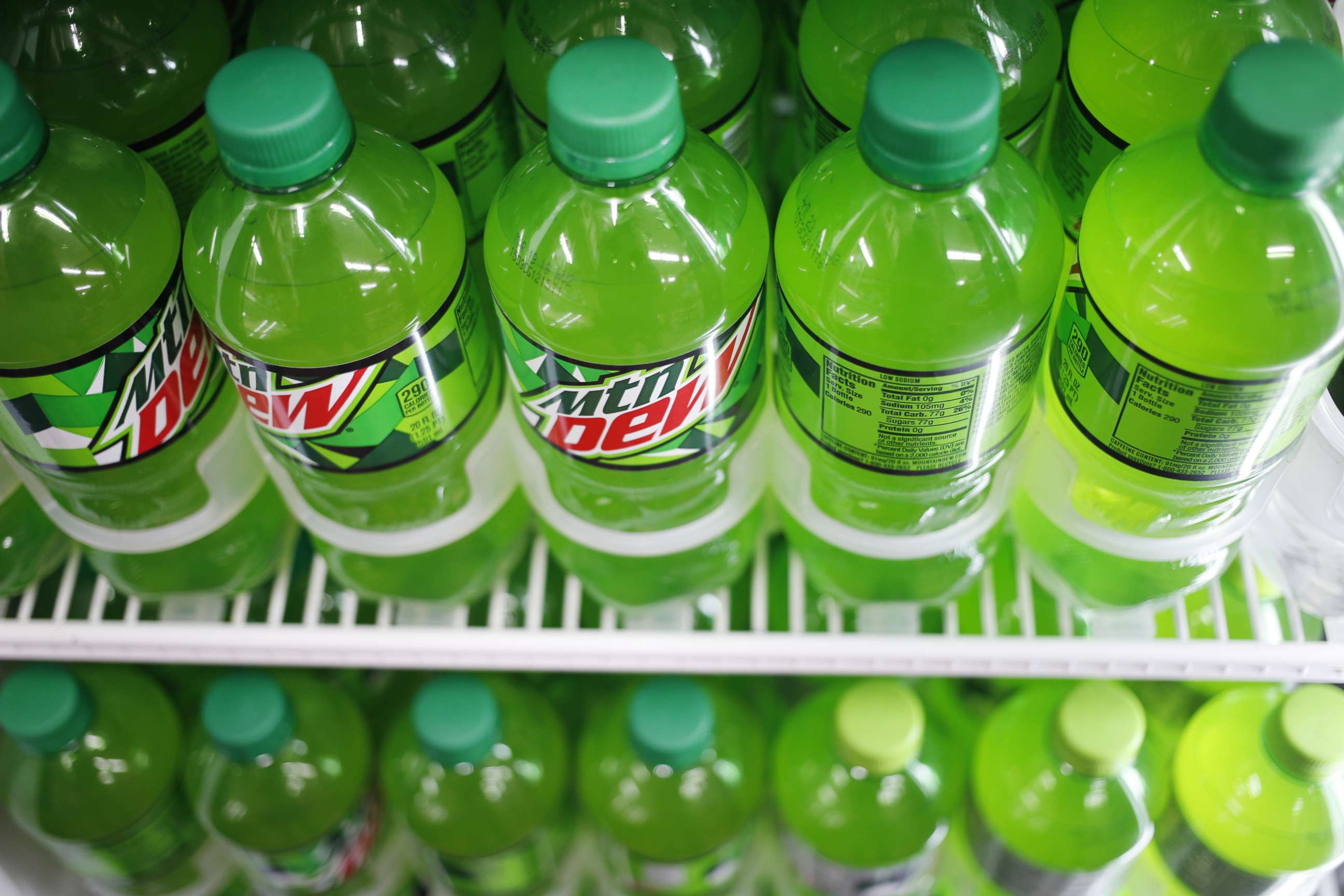 PHOTO: Bottles of PepsiCo Inc. Mountain Dew brand soda are displayed for sale inside a convenience store in Bagdad, Ky.,Feb. 11, 2018.