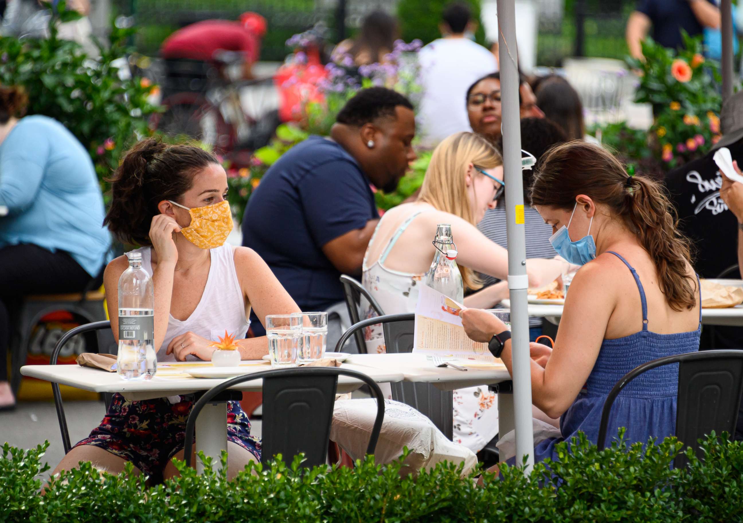 PHOTO: People wear protective face masks at an outdoor restaurant in the Flatiron District as the city continues Phase 4 of re-opening following restrictions imposed to slow the spread of coronavirus on July 26, 2020 in New York City.