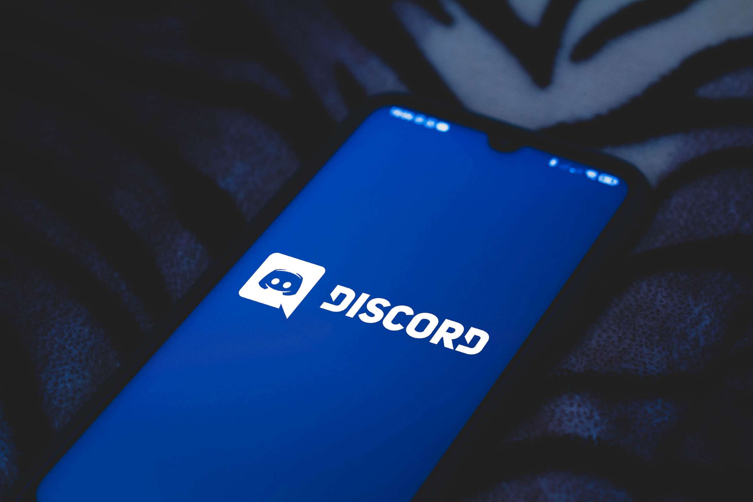 PHOTO: In this March 24, 2021, file photo, the Discord logo is displayed on a smartphone.