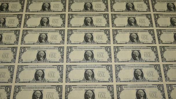 A sheet of freshly printed one dollar bills is ready for inspection at the Bureau of Engraving and Printing, March 24, 2015, in Washington, D.C.