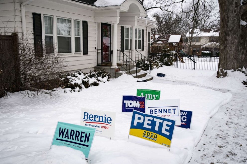 PHOTO: Campaign signs for 2020 Democratic presidential candidates stand in snow outside a home in Des Moines, Iowa, Jan. 30, 2020.