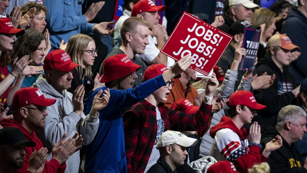 PHOTO: An attendee holds up a sign that reads "Jobs! Jobs! Jobs!" during a campaign rally for President Donald Trump in Des Moines, Iowa, Jan. 30, 2020.