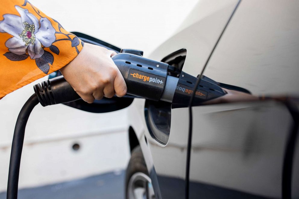 PHOTO: Maya Katz-Ali charges her electric car at a charging at a station along Lakeshore Avenue, Nov. 10, 2020, in Oakland, Calif.