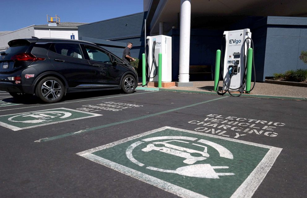 PHOTO: An electric car owner prepares to charge his car at an electric car charging station on Sept.23, 2020 in Corte Madera, Calif.