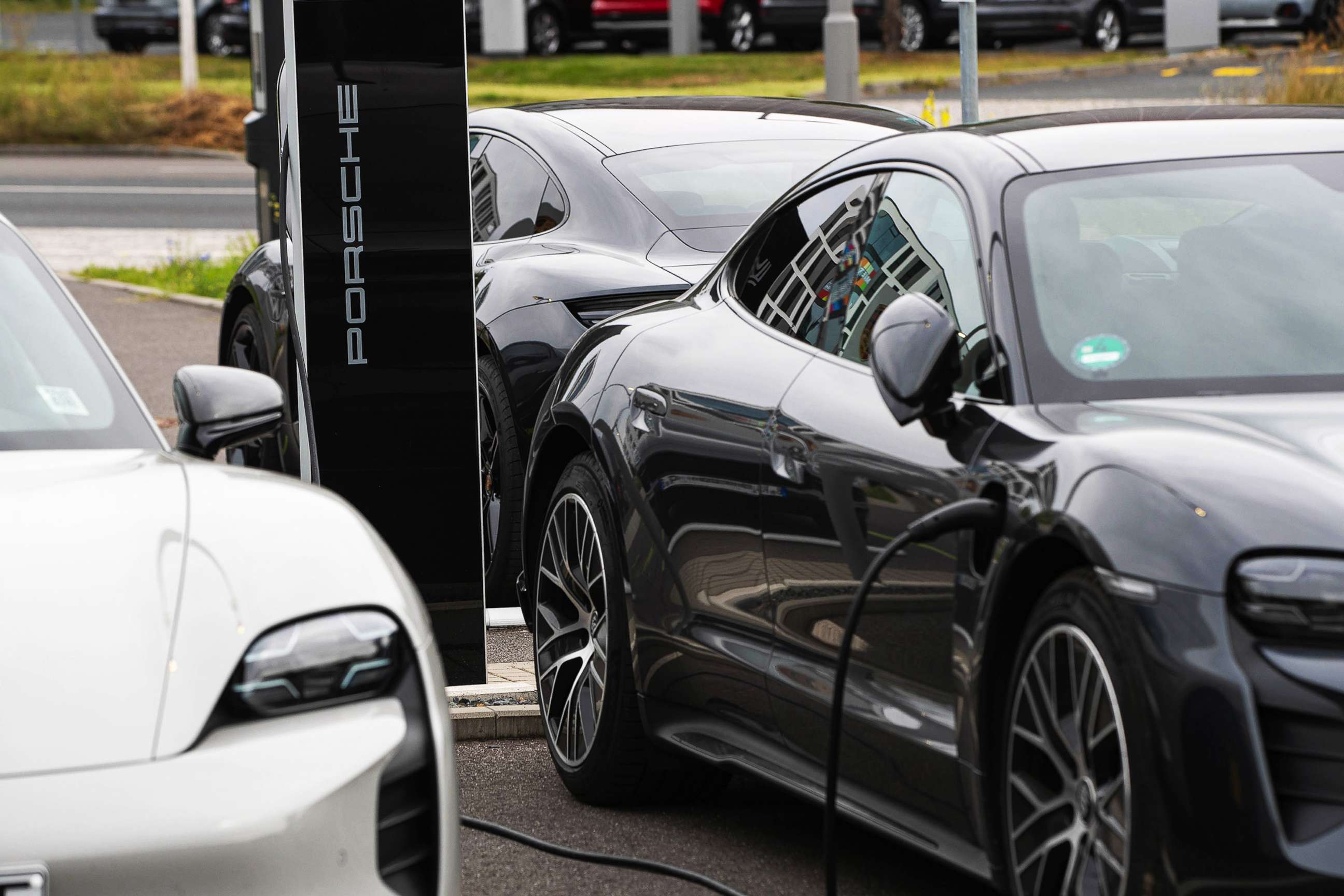 PHOTO: A Porsche Taycan electric automobile charges outside a Porsche SE showroom in Berlin, Aug. 9, 2021.