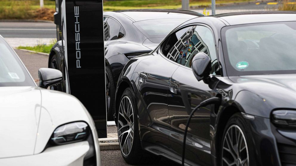 PHOTO: A Porsche Taycan electric automobile charges outside a Porsche SE showroom in Berlin, Aug. 9, 2021.