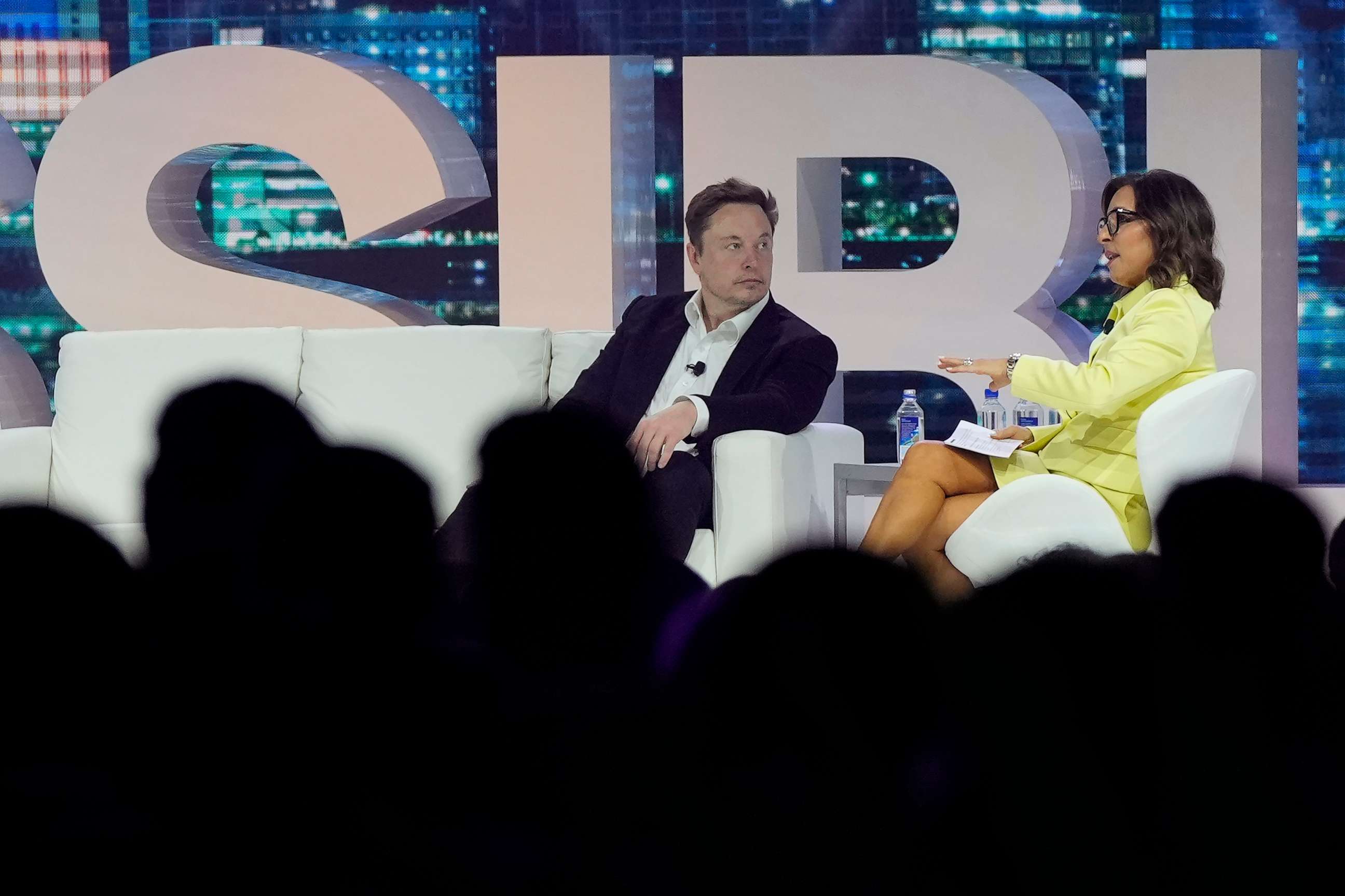 PHOTO: Twitter CEO Elon Musk, center, speaks with Linda Yaccarino, chairman of global advertising and partnerships for NBC, at the POSSIBLE marketing conference, April 18, 2023, in Miami Beach, Fla.