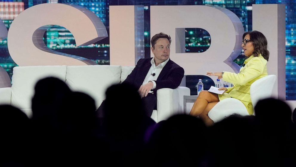 PHOTO: Twitter CEO Elon Musk, center, speaks with Linda Yaccarino, chairman of global advertising and partnerships for NBC, at the POSSIBLE marketing conference, April 18, 2023, in Miami Beach, Fla.