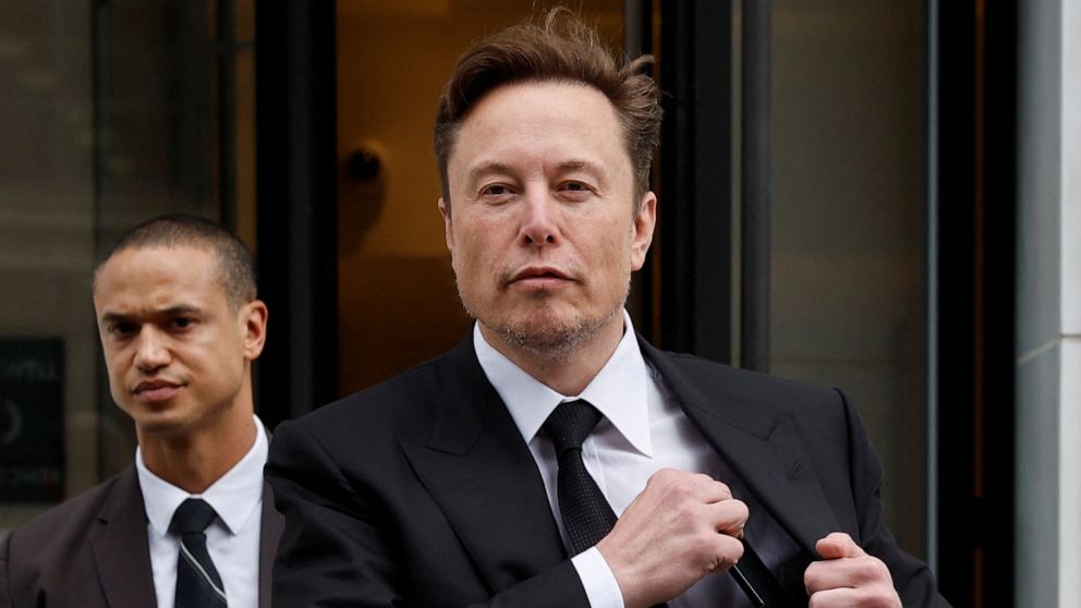 PHOTO: Tesla CEO Elon Musk and his security detail depart the company office in Washington, Jan. 27, 2023.