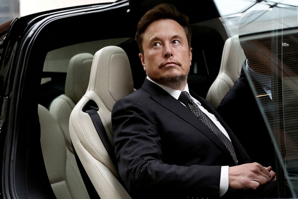 PHOTO: Elon Musk gets in a Tesla car as he leaves a hotel in Beijing, China May 31, 2023.