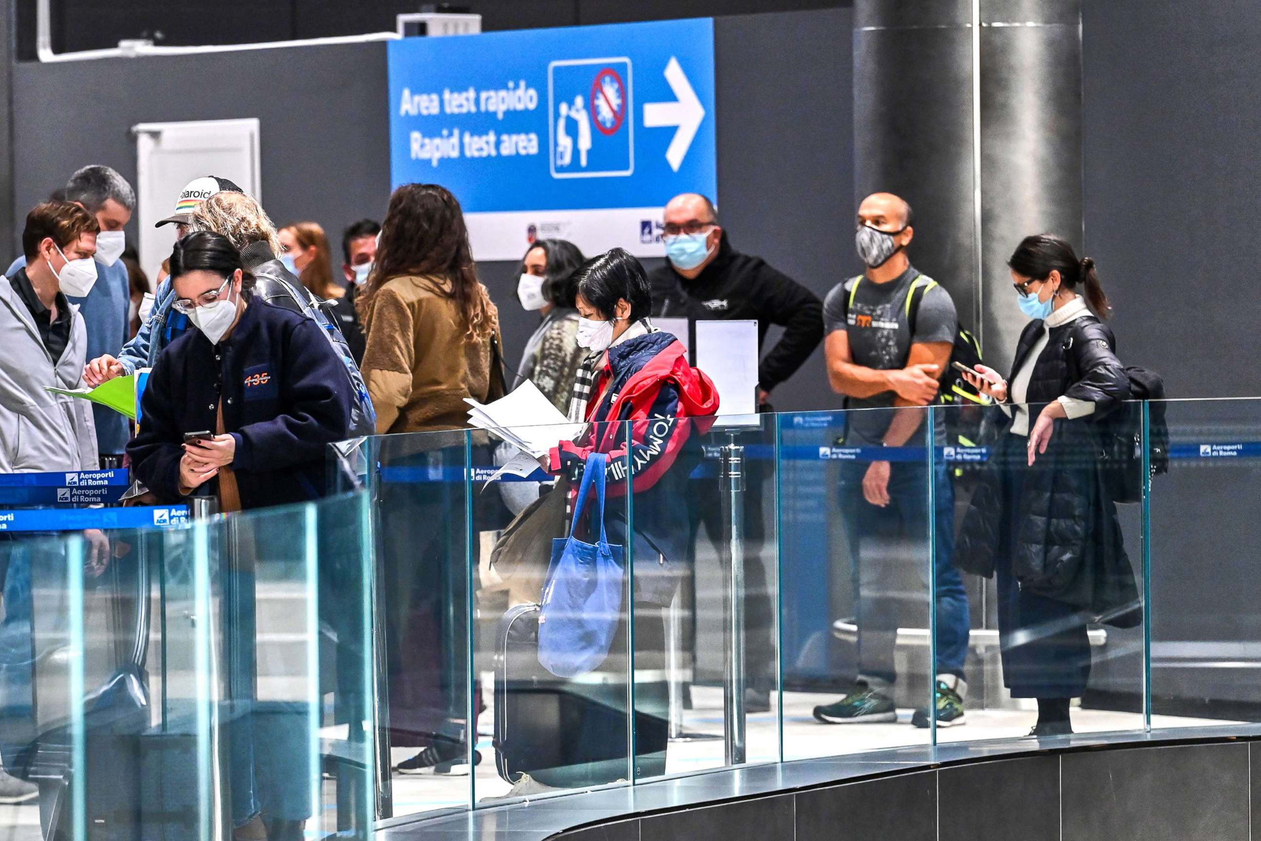 PHOTO: Passengers who came from New York on an Alitalia flight wait in line to undergo a test for COVID-19 at a Rapid Test Area set up at Rome's Fiumicino airport, Dec.9, 2020.