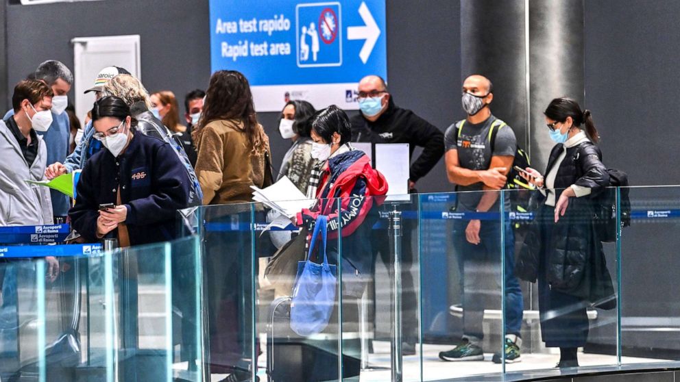 PHOTO: Passengers who came from New York on an Alitalia flight wait in line to undergo a test for COVID-19 at a Rapid Test Area set up at Rome's Fiumicino airport, Dec.9, 2020.