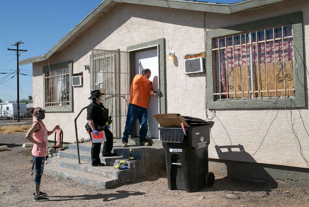 PHOTO: In this Oct. 1, 2020, file photo, a maintenance man breaks the lock of a house as Maricopa County constable Darlene Martinez serves an eviction order in Phoenix.