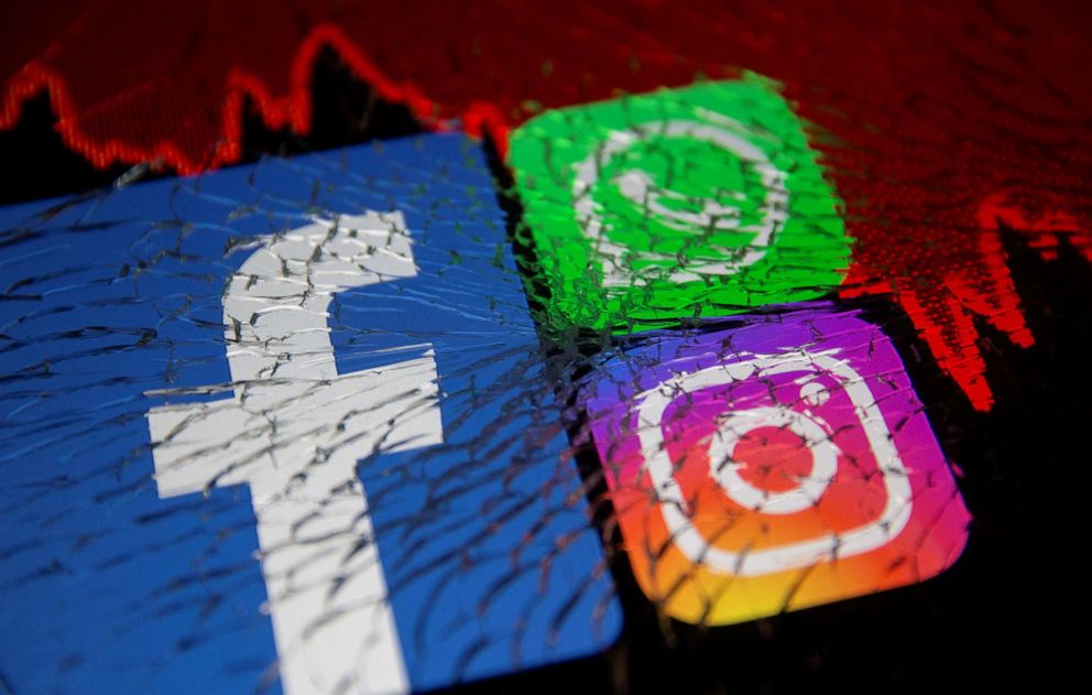 PHOTO: Facebook, Whatsapp and Instagram logos and stock graph are displayed through broken glass in an image from Oct. 4, 2021.