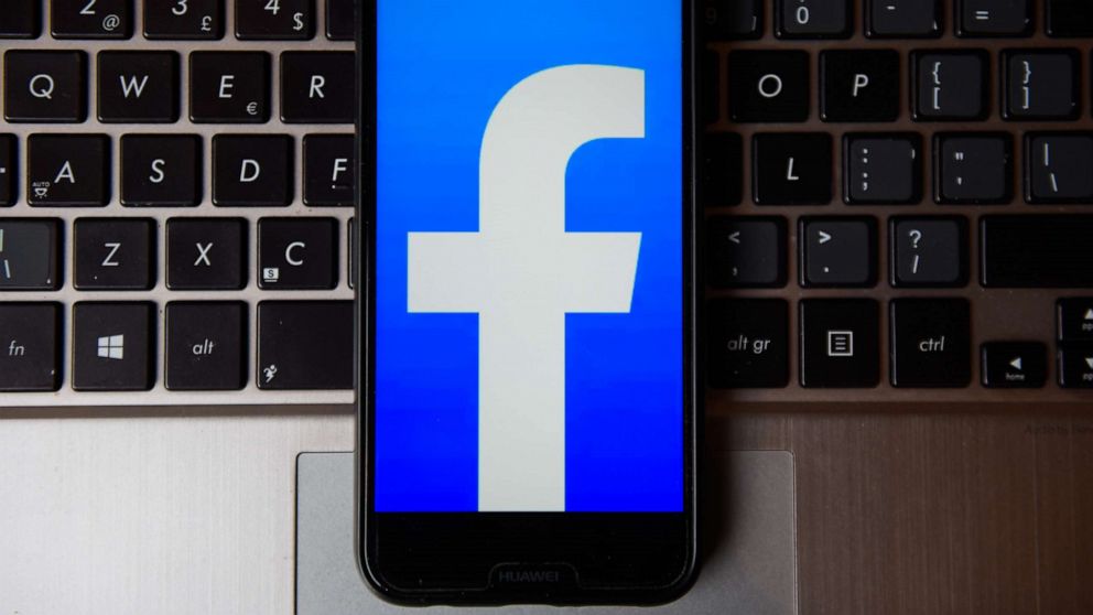 PHOTO: In this photo illustration a Facebook logo seen displayed on a smartphone on a laptop keyboard.