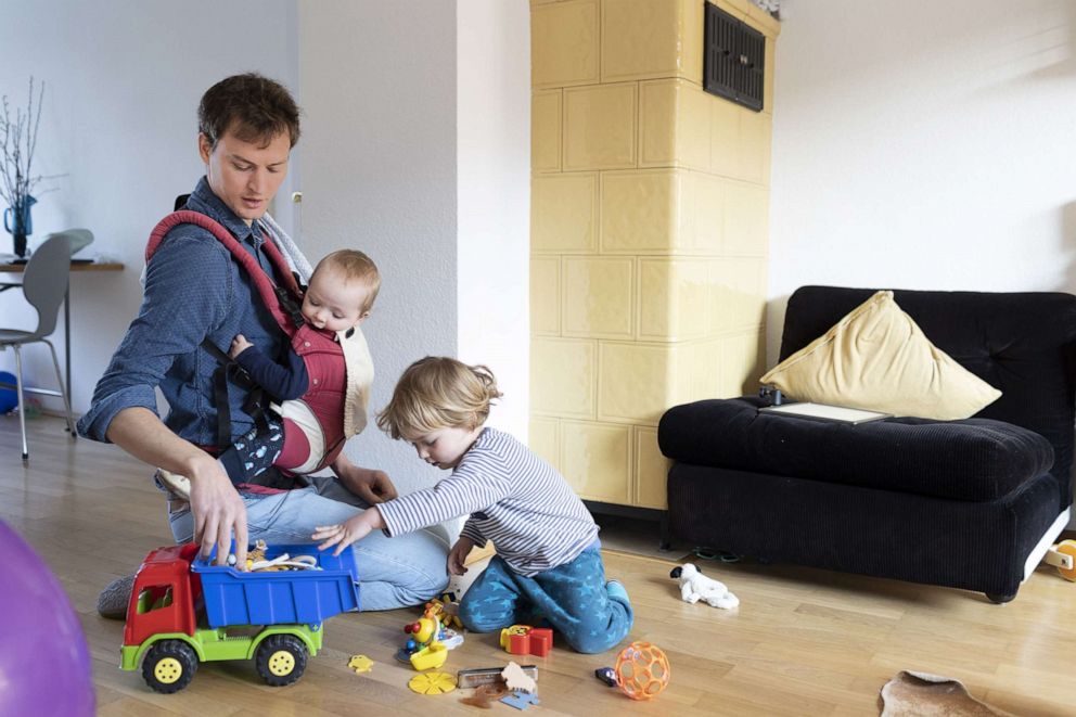 PHOTO: A father is shown playing in the livingroom with small children. (Photo Illustration by Ute Grabowsky/Getty Images)