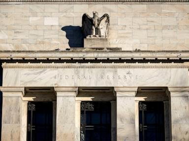 Fed holds interest rates, setting potential collision course with Trump