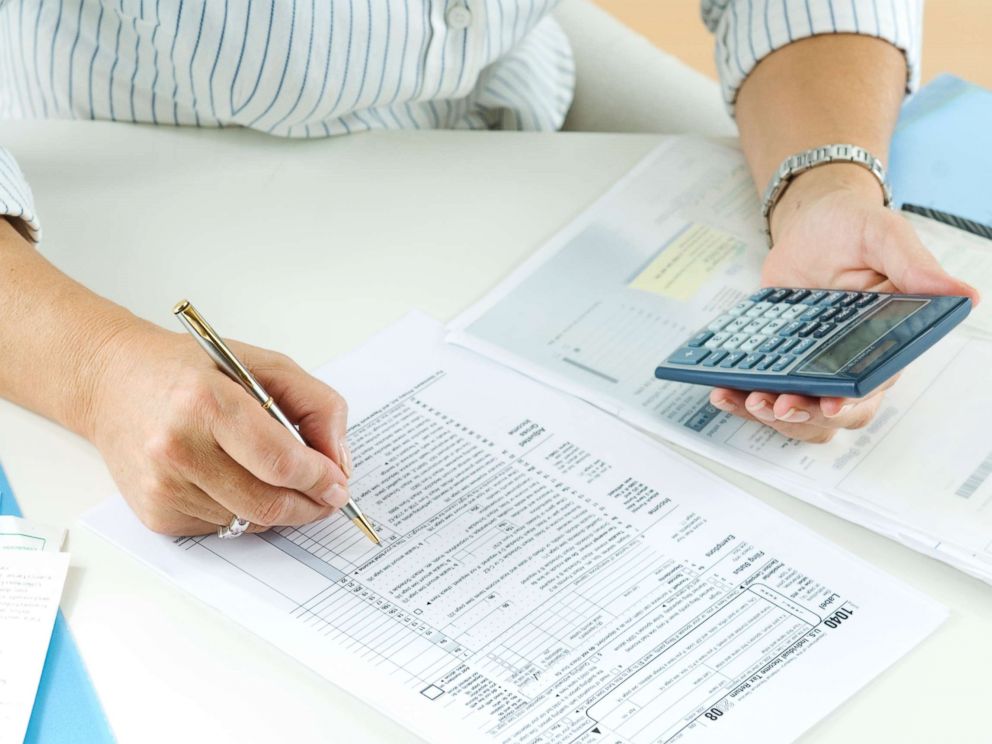 PHOTO: A woman calculates her taxes in this undated stock photo.