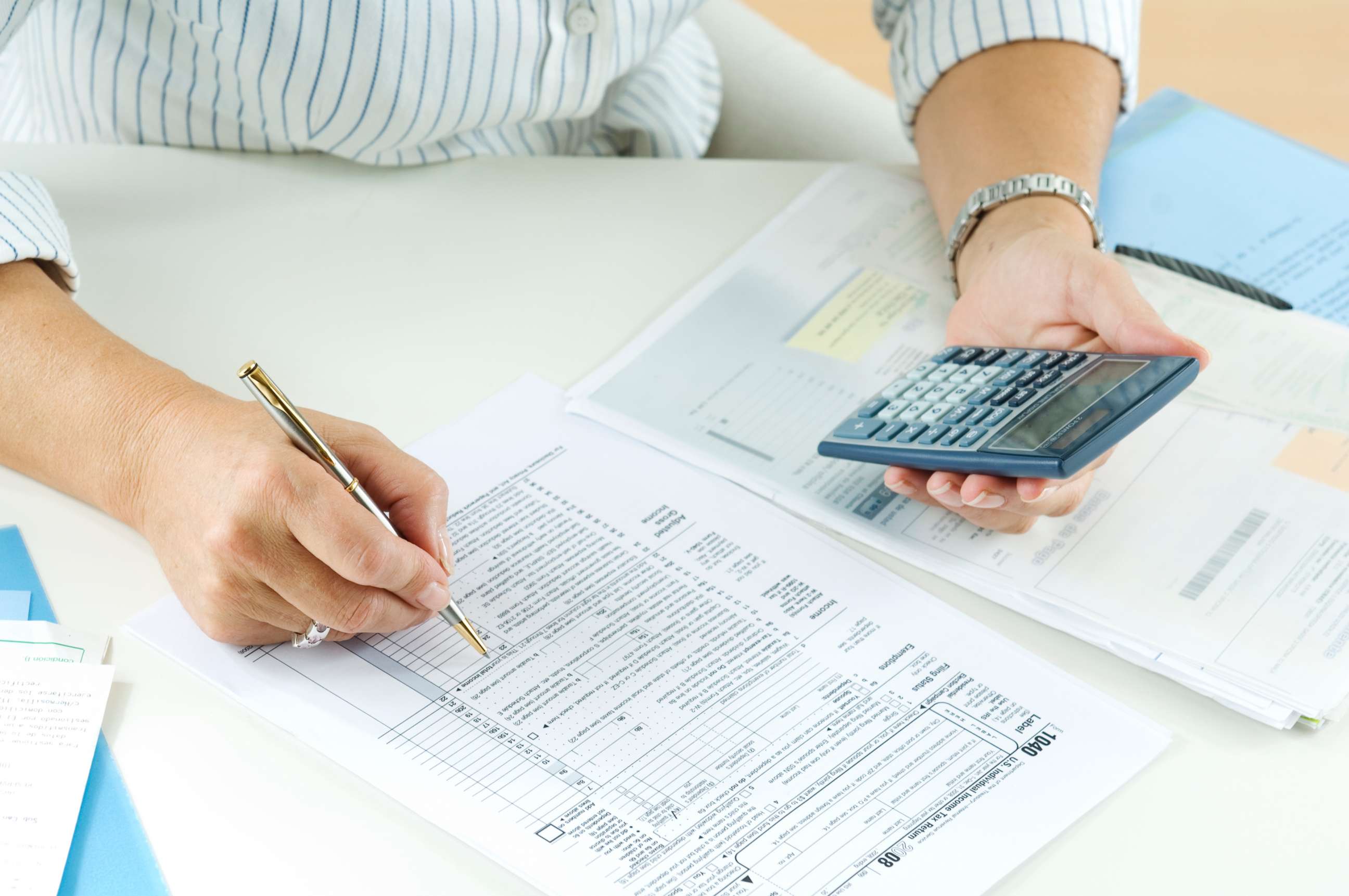 PHOTO: A woman calculates her taxes in this undated stock photo.