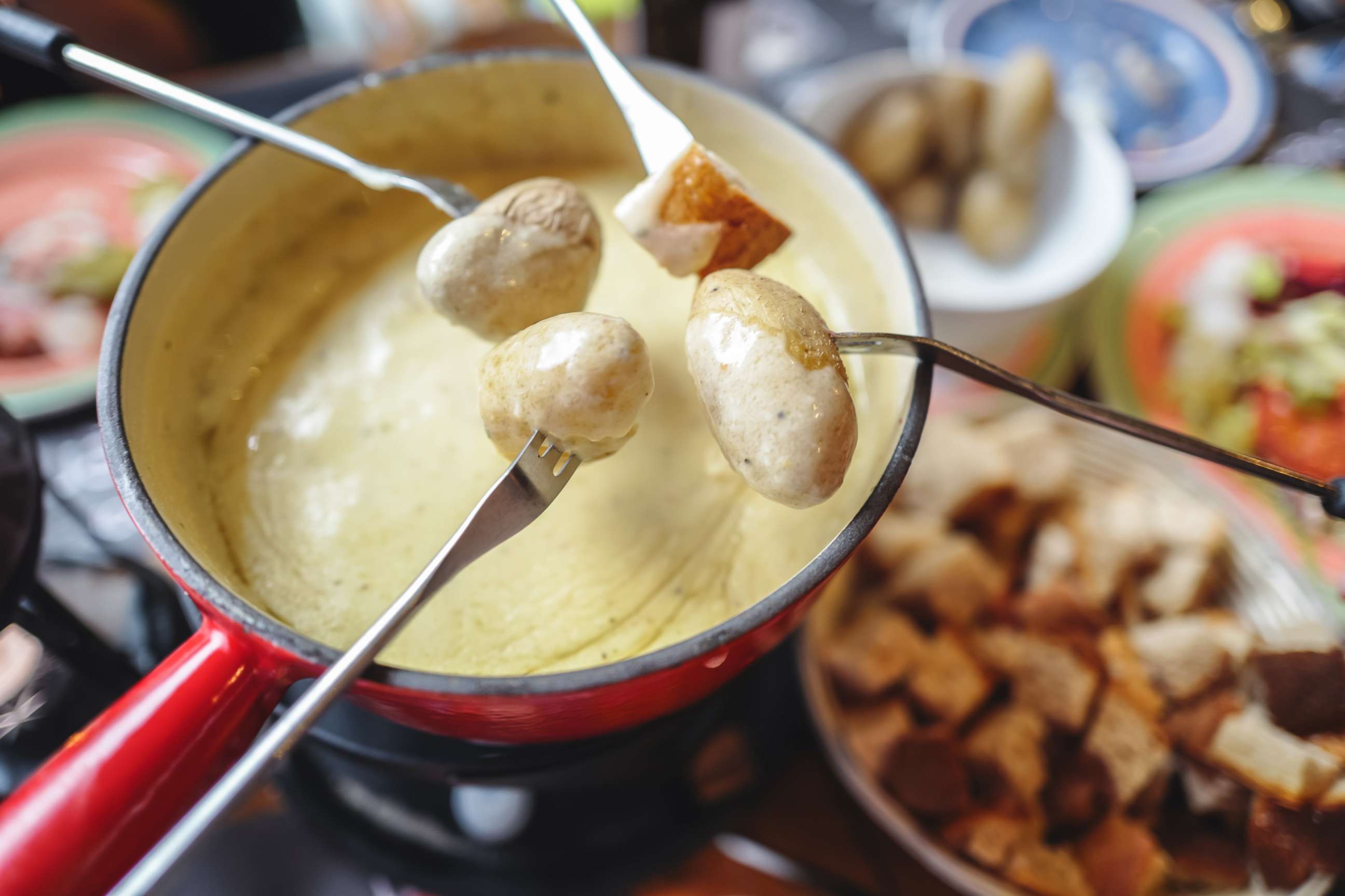 PHOTO: Swiss cheese fondue is served in an earthenware pot.