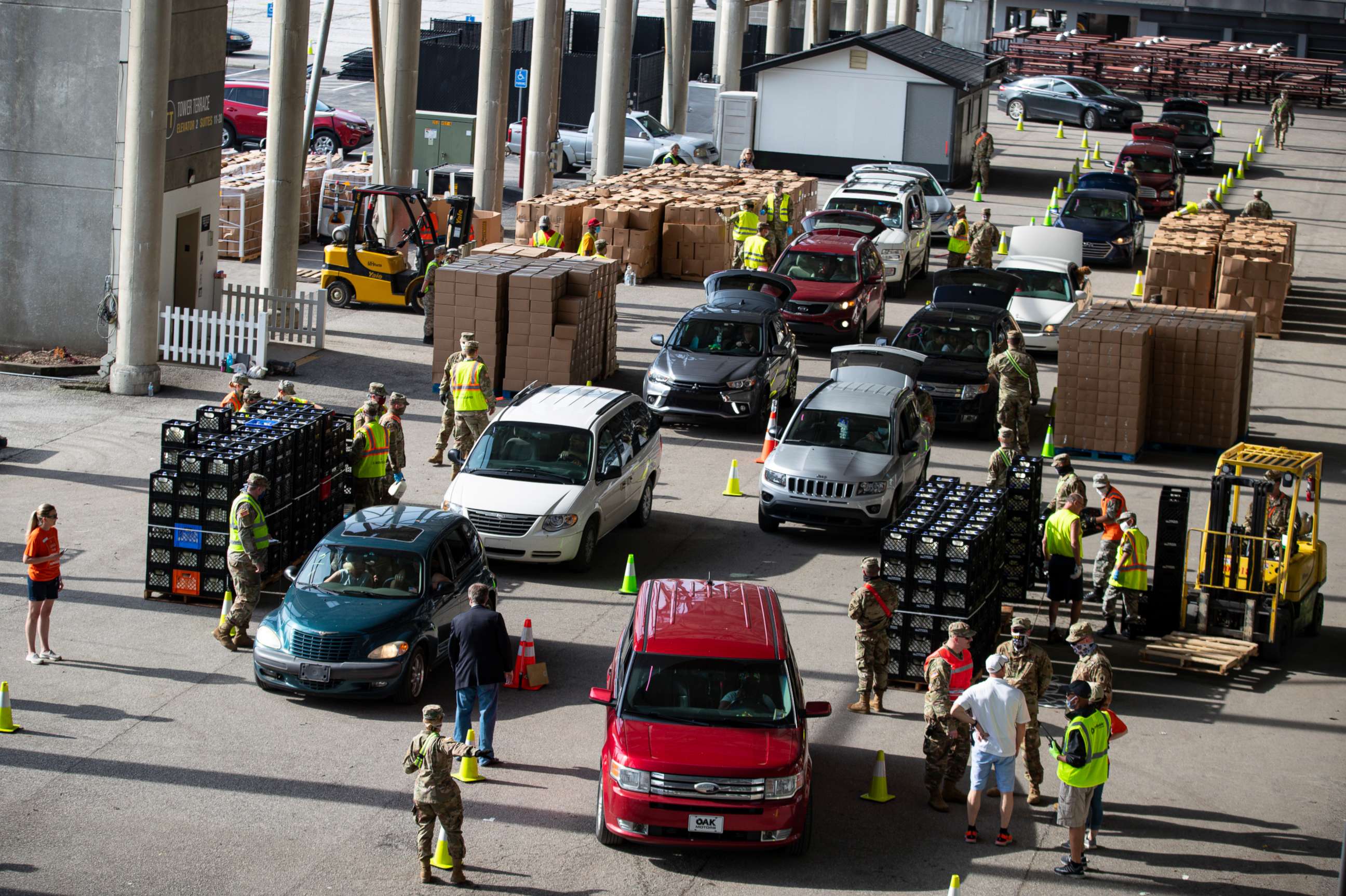 PHOTO: Vehicles move through a food distribution line at the Indianapolis Motor Speedway in Indianapolis, May 23, 2020, for a mobile food distribution event. 