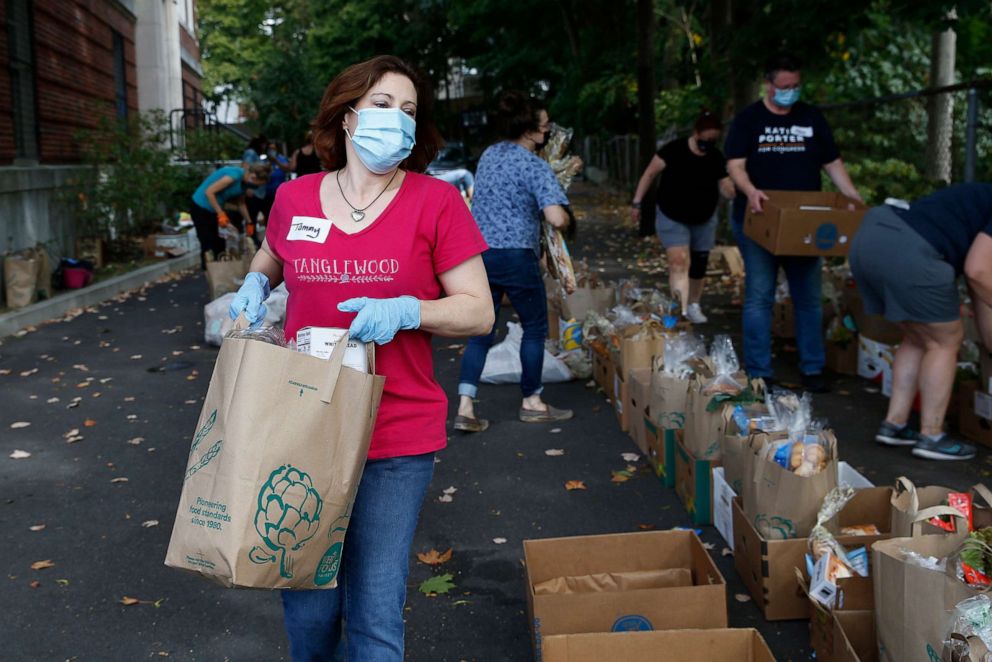 PHOTO: In this Sept. 27, 2020, file photo, Tammy Lynch volunteers at a pickup site for food distribution with the Roslindale Collective in Boston.