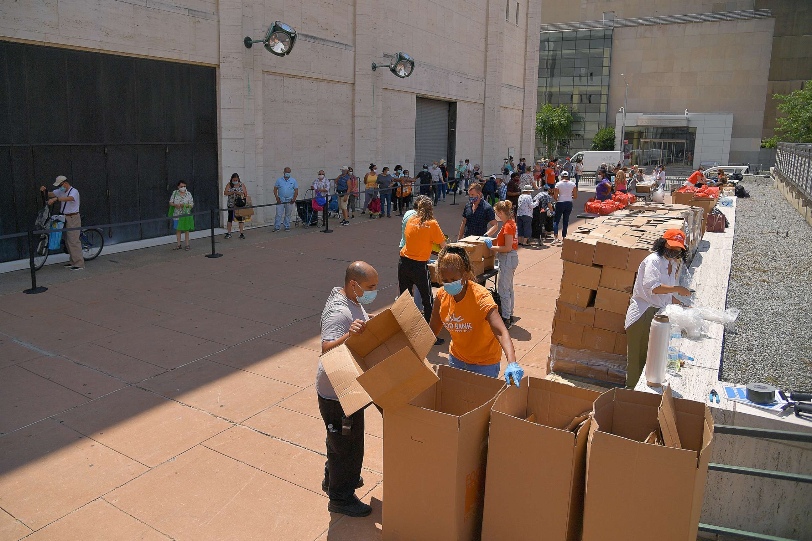 PHOTO: New Yorkers in need receive free produce, dry goods, and meat at a Food Bank For New York City distribution event at Lincoln Center on July 29, 2020 in New York City.