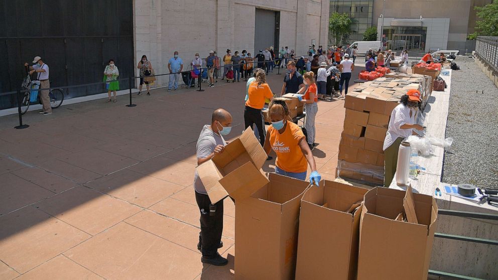 PHOTO: New Yorkers in need receive free produce, dry goods, and meat at a Food Bank For New York City distribution event at Lincoln Center on July 29, 2020 in New York City.