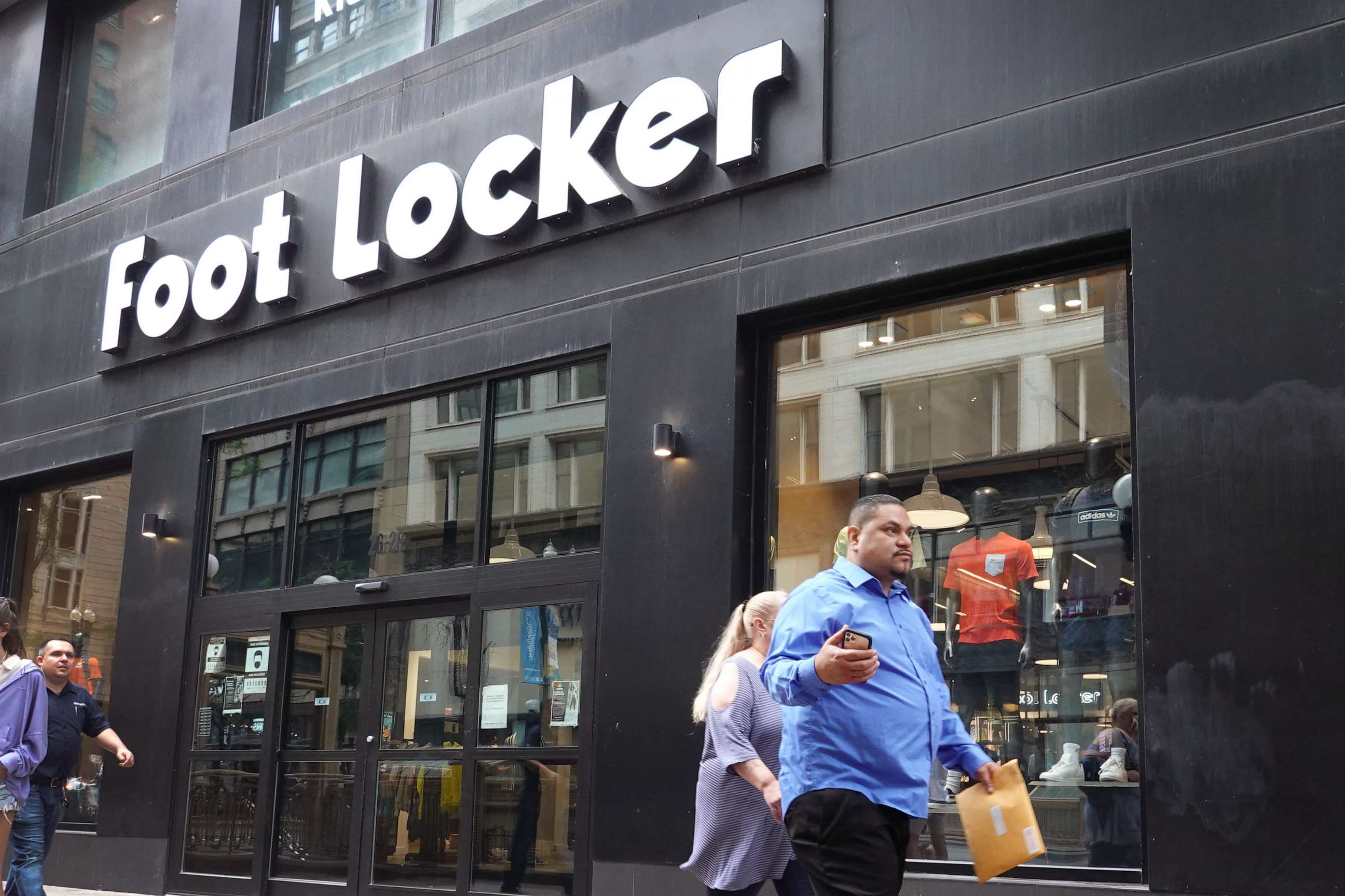 PHOTO: A sign hangs above the entrance of a Foot Locker store, Aug. 2, 2021, in Chicago.