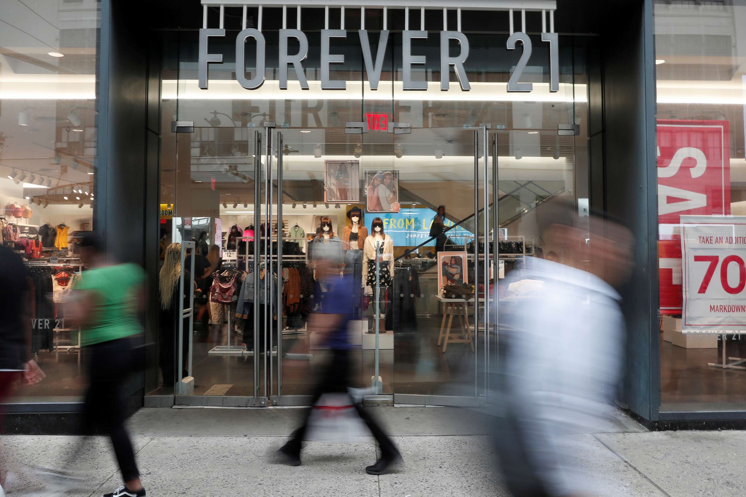 PHOTO: People walk by the clothing retailer Forever 21 in New York City, Sept. 12, 2019.