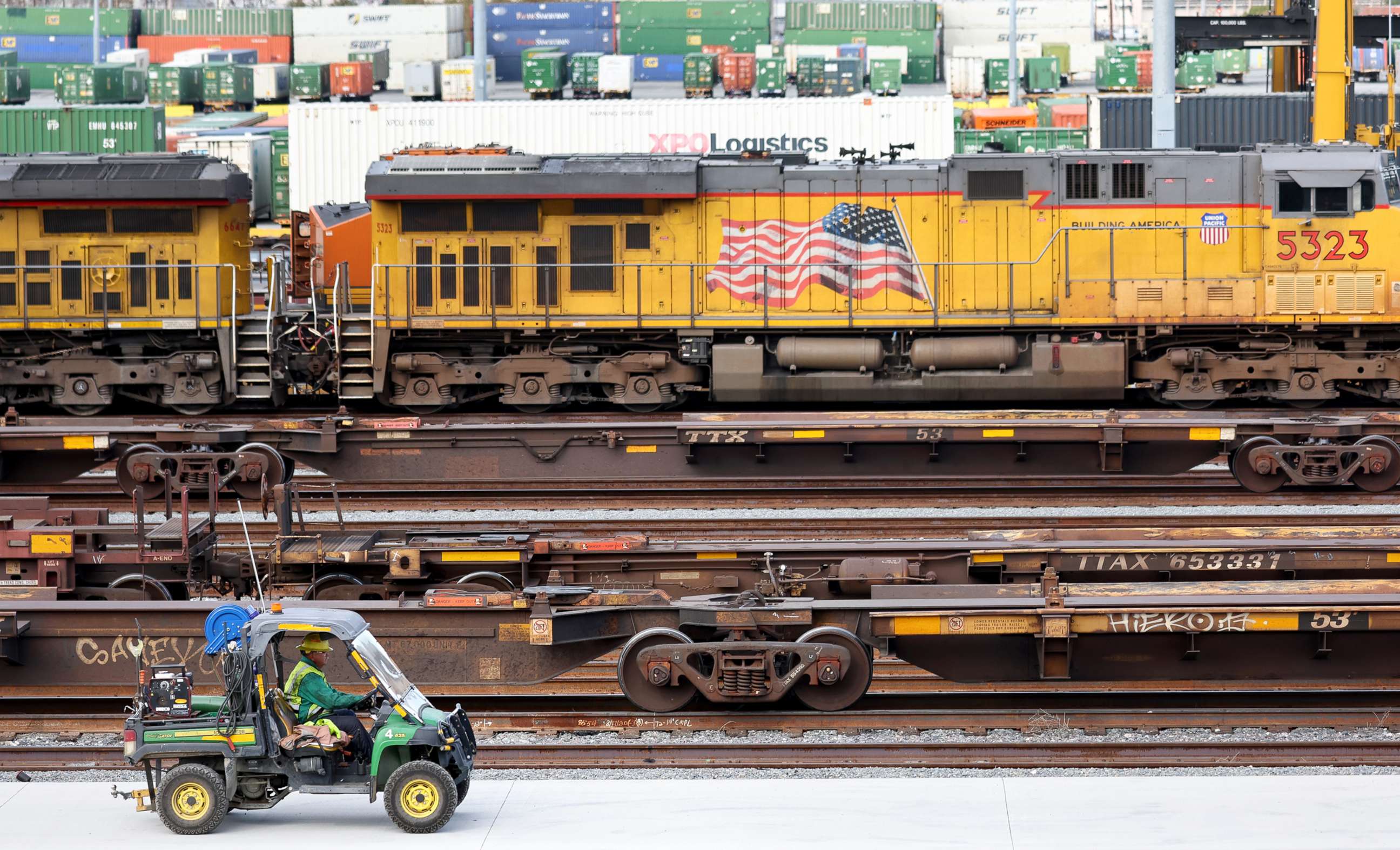 PHOTO: A worker drives near freight trains and shipping containers in a Union Pacific Intermodal Terminal rail yard on Nov. 21, 2022, in Los Angeles.