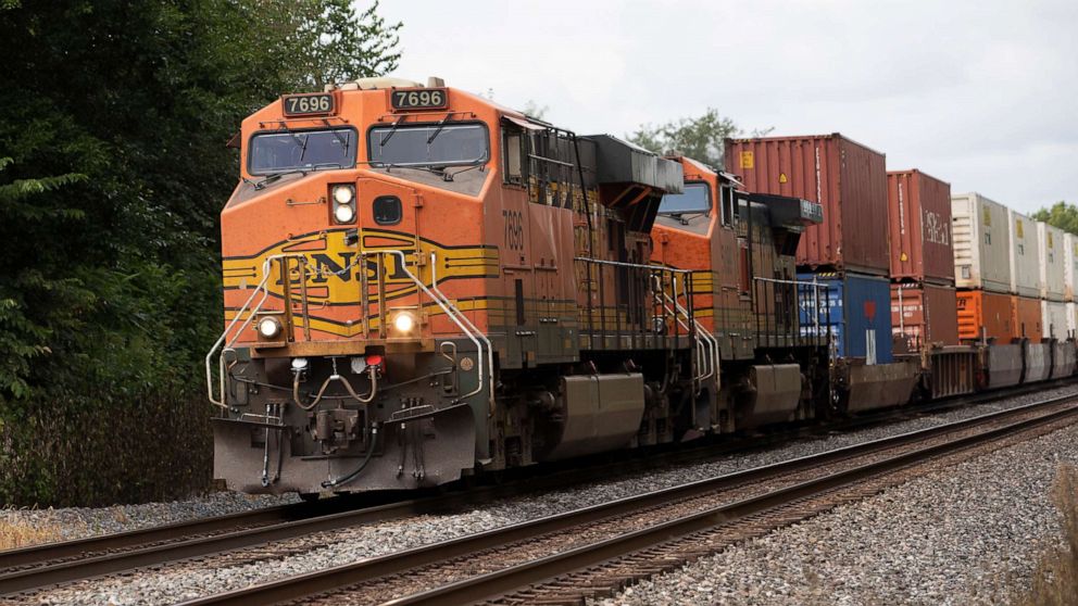 PHOTO: A freight train with BNSF locomotives traverses a grade crossing along a CSX line Aug. 26, 2022, near Albion, Ind.