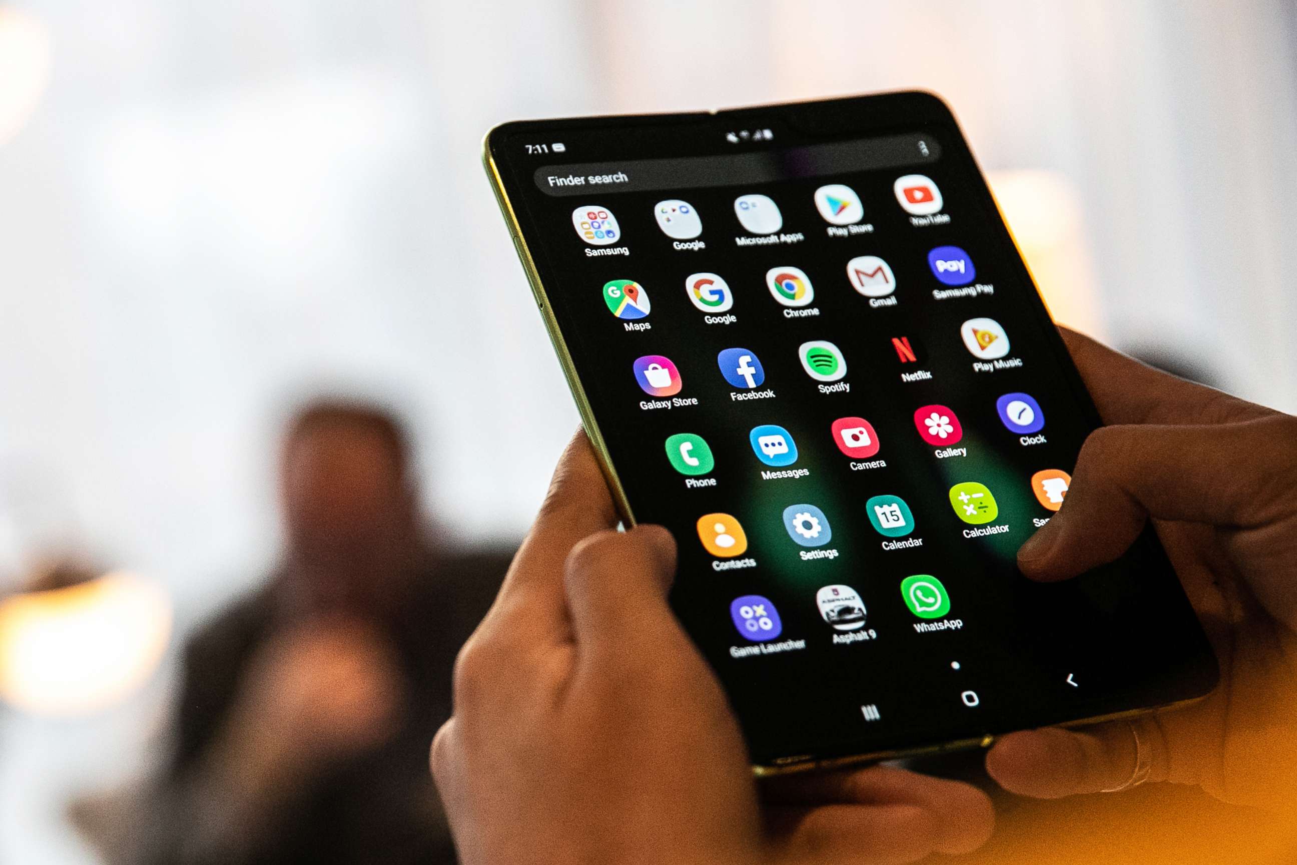 PHOTO: An attendee holds a Samsung Electronics Co. Galaxy Fold mobile device during an unveiling event in New York, on April 15, 2019.