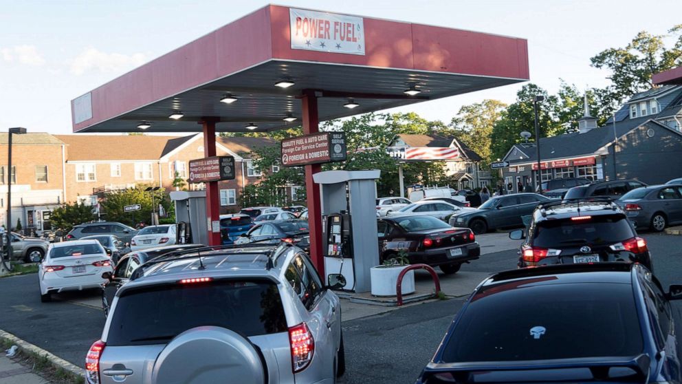 PHOTO: Cars line up for fuel at a gas station in Arlington, Va., May 12, 2021.