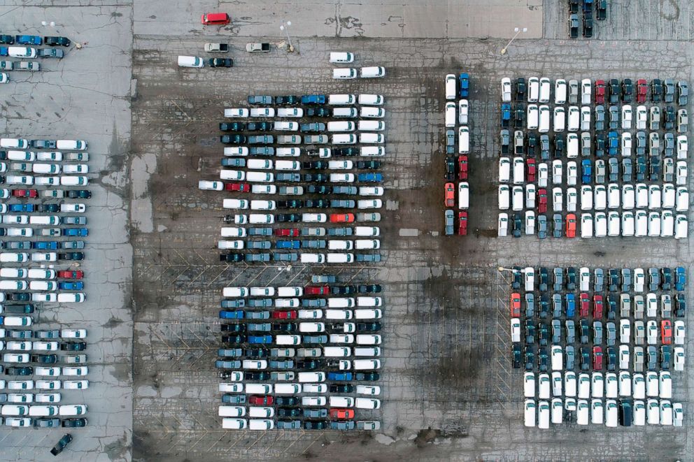 PHOTO: In this aerial photo, mid-sized pickup trucks and full-size vans are seen in a parking lot outside a General Motors assembly plant where they are produced, March 24, 2021, in Wentzville, Mo.