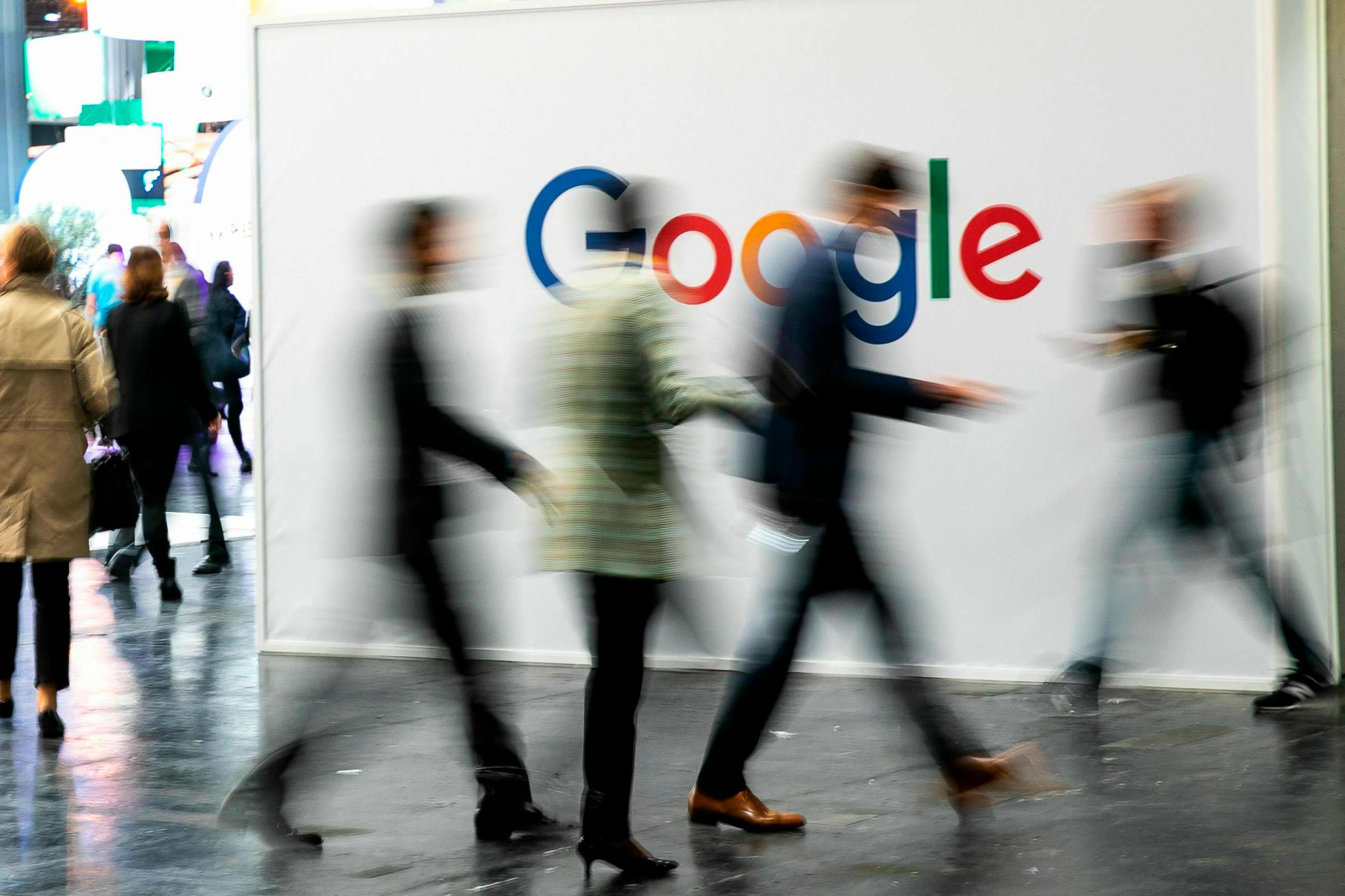 PHOTO: People walk past Google signage at a technology conference in Paris, May 17, 2019.