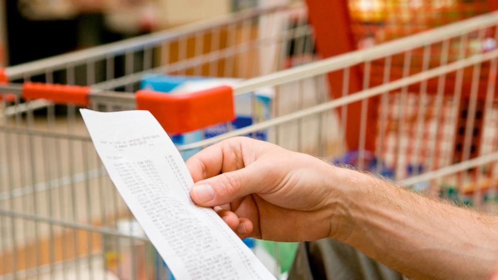 PHOTO: In this undated stock photo, a supermarket customer looks at the prices of groceries on their receipt. 
