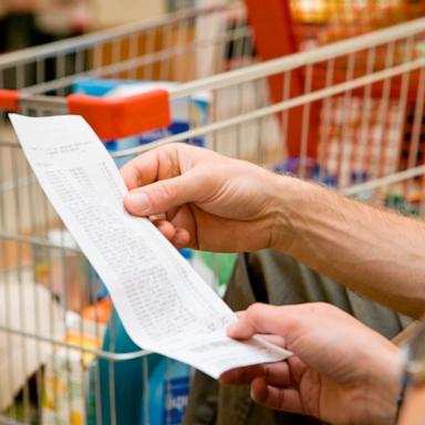 PHOTO: In this undated stock photo, a supermarket customer looks at the prices of groceries on their receipt. 