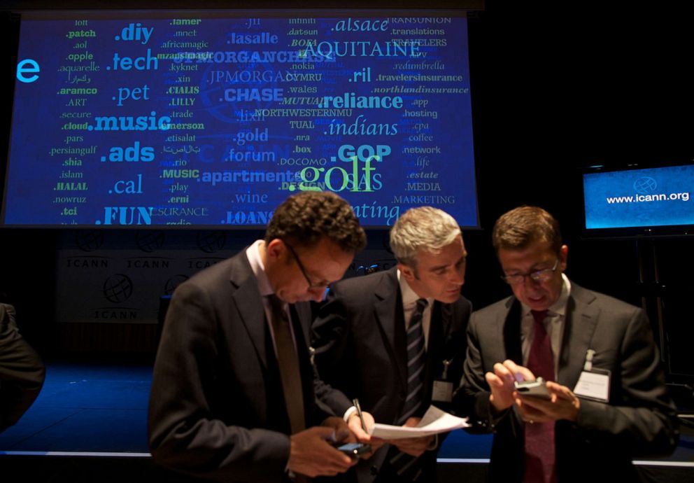 PHOTO: Journalists examine new 'Generic Top-Level Domain Names (gTLDs) during a press conference hosted by ICANN in central London, June 13, 2012.