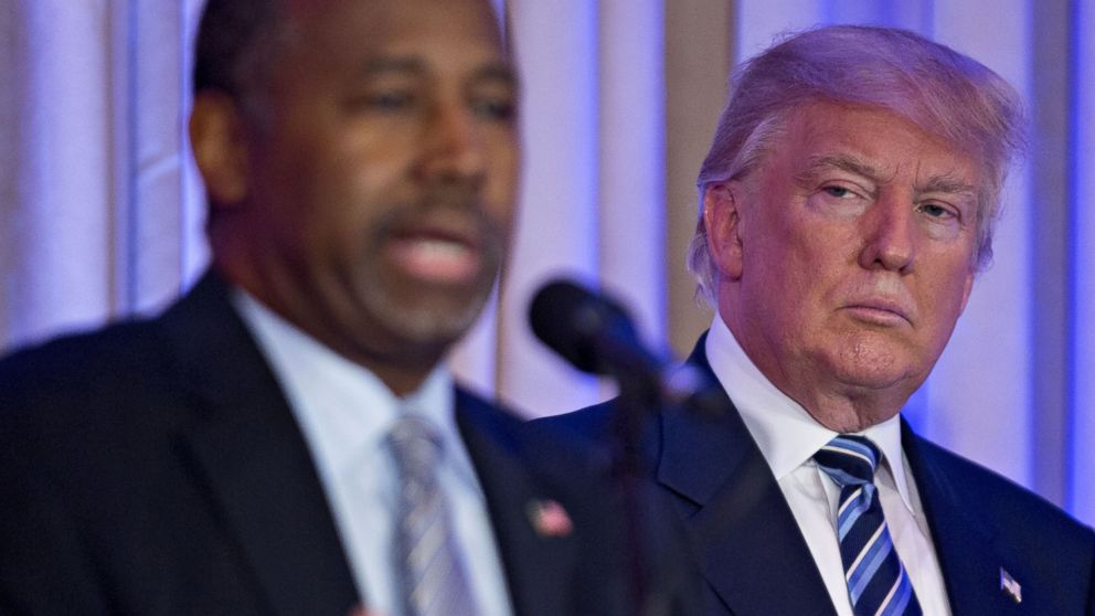 Donald Trump looks on as Ben Carson speaks during a news conference at the Mar-A-Lago Club in Palm Beach, Fla., on March 11, 2016.