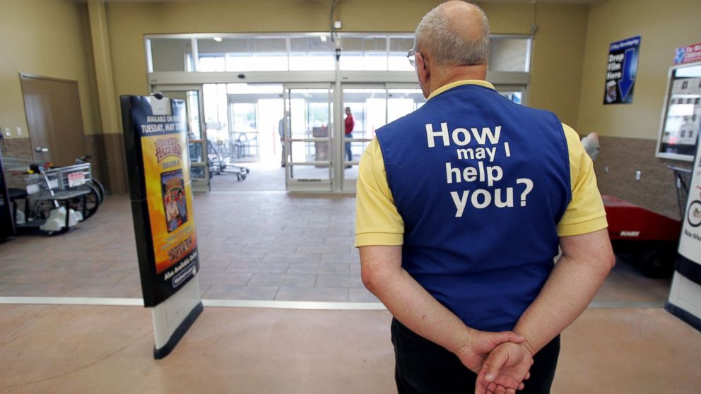 A Wal-Mart greeter waits to welcome new customers to the new 2,000 square foot Wal-Mart Supercenter store May 17, 2006 in Bowling Green, Ohio. 