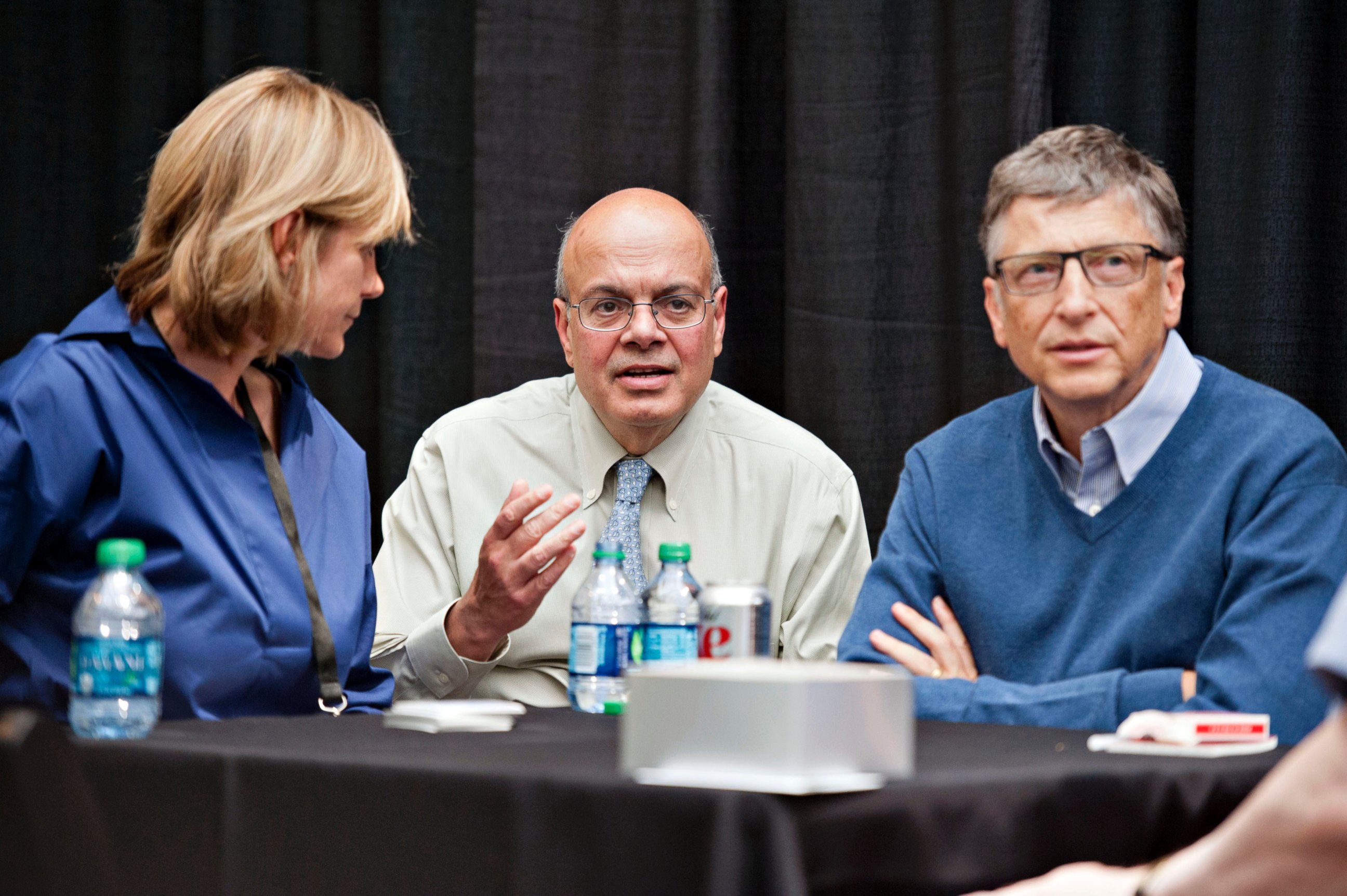 PHOTO: Ajit Jain, head of the Berkshire Hathaway reinsurance business, center, sits next to Bill Gates, chairman and founder of Microsoft Corp. at the Berkshire Hathaway shareholders meeting in Omaha, Nebraska,  May 4, 2014. 