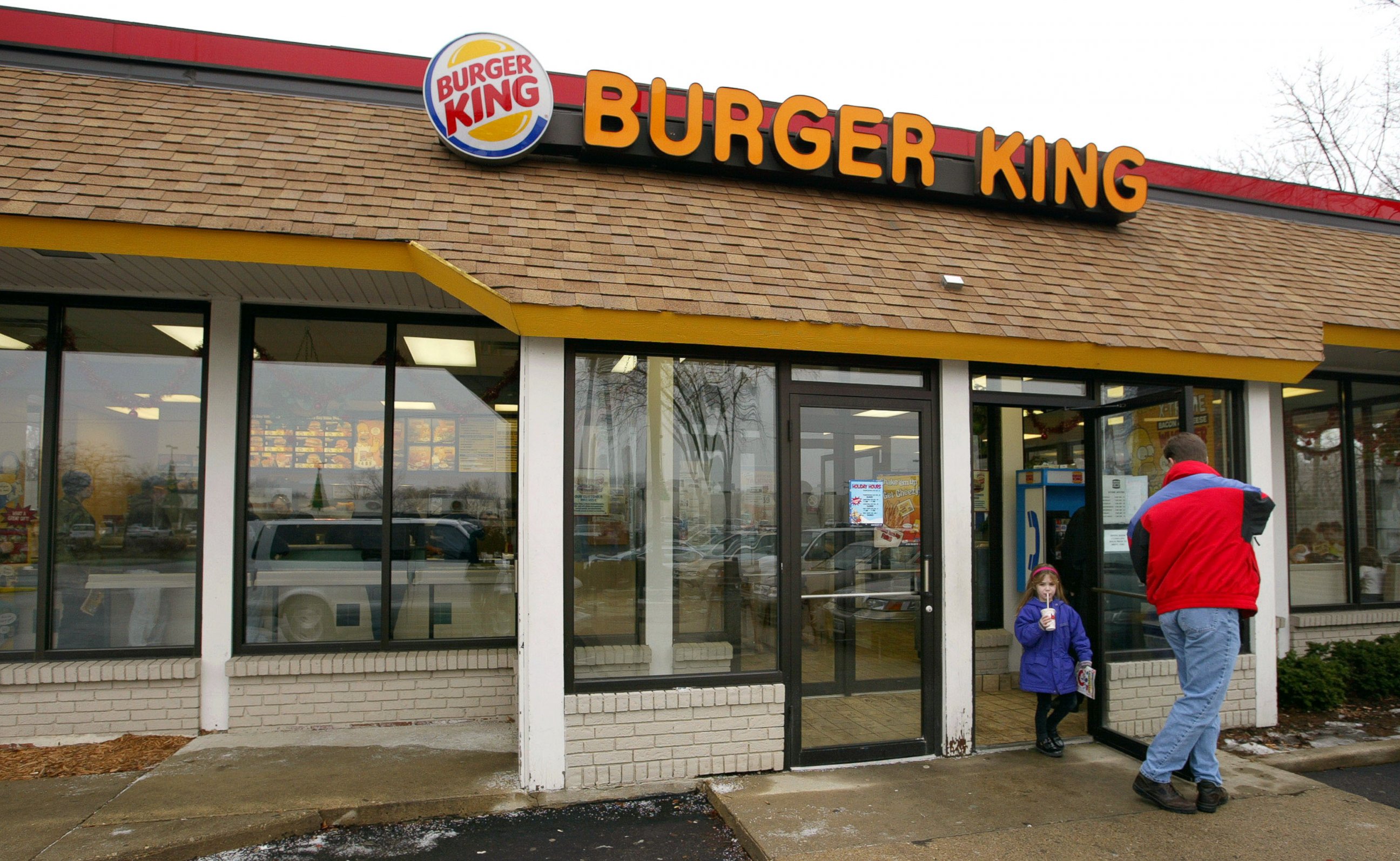 PHOTO: Customers leave a Burger King restaurant December 13, 2002 in Park Ridge, Illinois. 