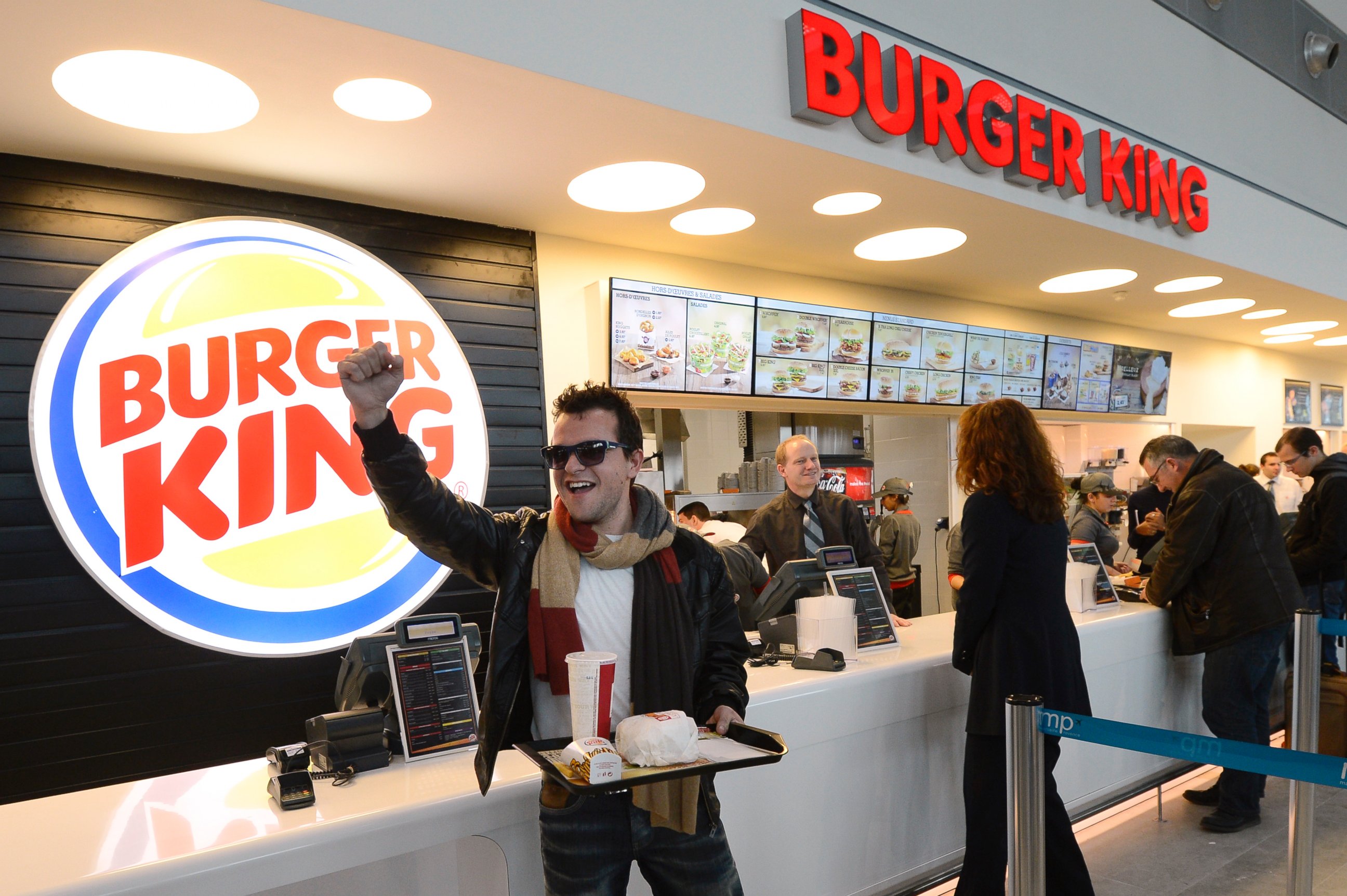 PHOTO: A customer reacts after being served at the Burger King fast food restaurant in Marseille's airport, in Marignane, southern France, on Dec. 22, 2012.